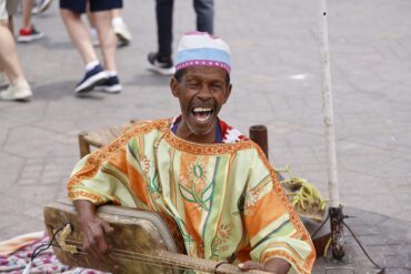 Vibrant scene from a cultural festival in Marrakech, Morocco, showcasing traditional Moroccan music and dance, perfect for an authentic cultural vacation.