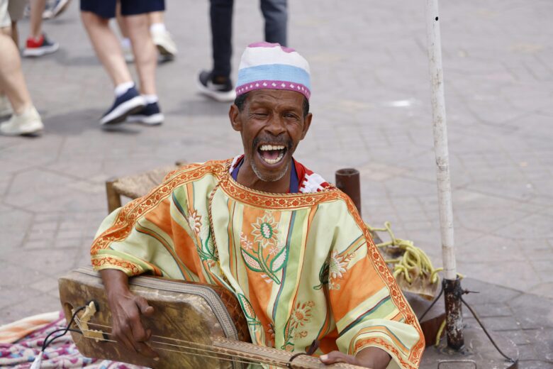 Vibrant scene from a cultural festival in Marrakech, Morocco, showcasing traditional Moroccan music and dance, perfect for an authentic cultural vacation.