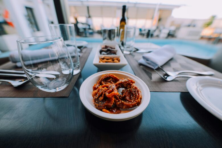 Lavish buffet at Valeria Dar Atlas Marrakech resort, showcasing authentic Moroccan cuisine like tagine and couscous alongside diverse international dishes, in an elegant and inviting dining setting.