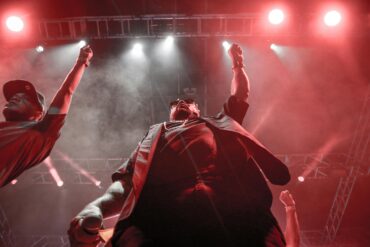 Vibrant Moroccan night cultural show at a luxury Marrakech resort, featuring traditional dancers and live Gnaoua music, creating an unforgettable authentic evening entertainment experience in Morocco.