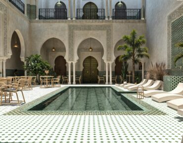 A happy family relaxing by a clean resort pool in Marrakech, Morocco, symbolizing a safe, hygienic, and worry-free all-inclusive vacation experience.