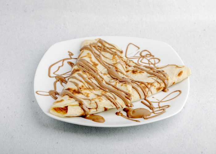 crepe-with-chocolate-cocoa-syrup-white-plate-white-background (1)