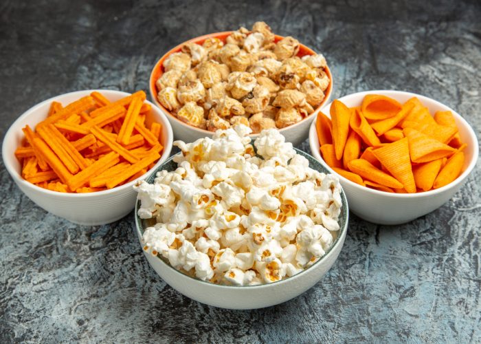 front-view-different-snacks-movie-time-light-dark-background